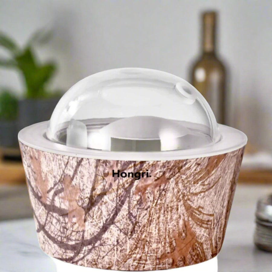 Autumn Leaves Essential & Fragrance Oil Diffuser on a wooden table, surrounded by colorful autumn leaves.