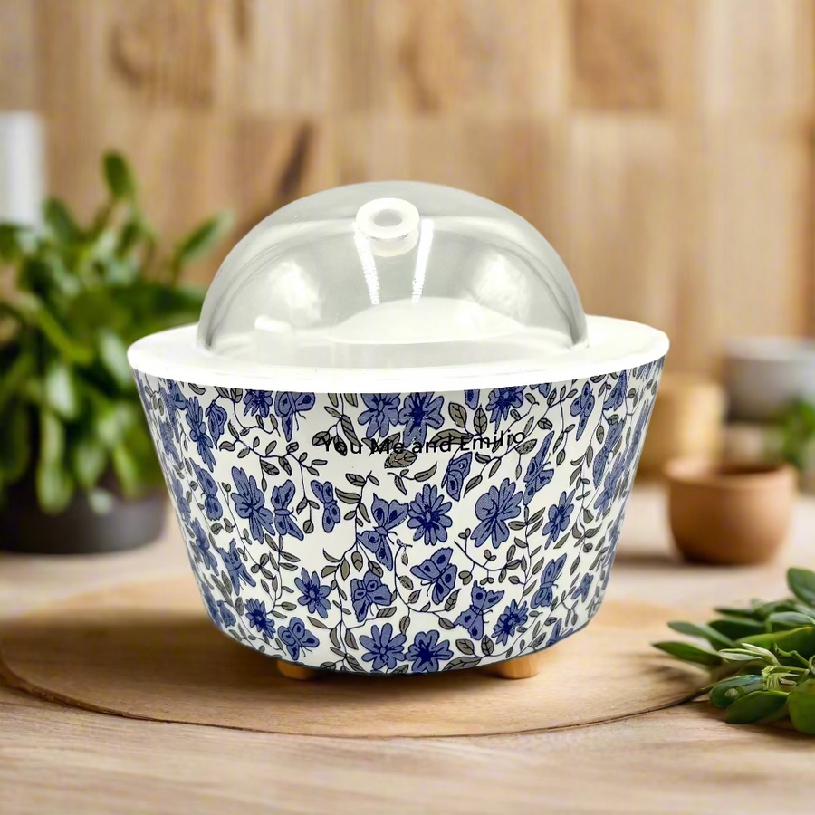 Decorative ceramic container with blue floral pattern on a white background