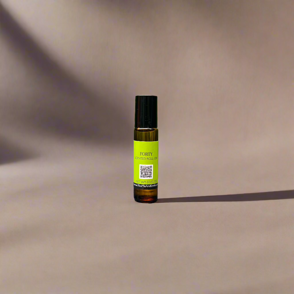 Amber glass bottle of Forty Scented Roll-On by You Me & Emilio, featuring bold musky and floral fragrance oil for daily wear, luxury scent rituals, and gifting.