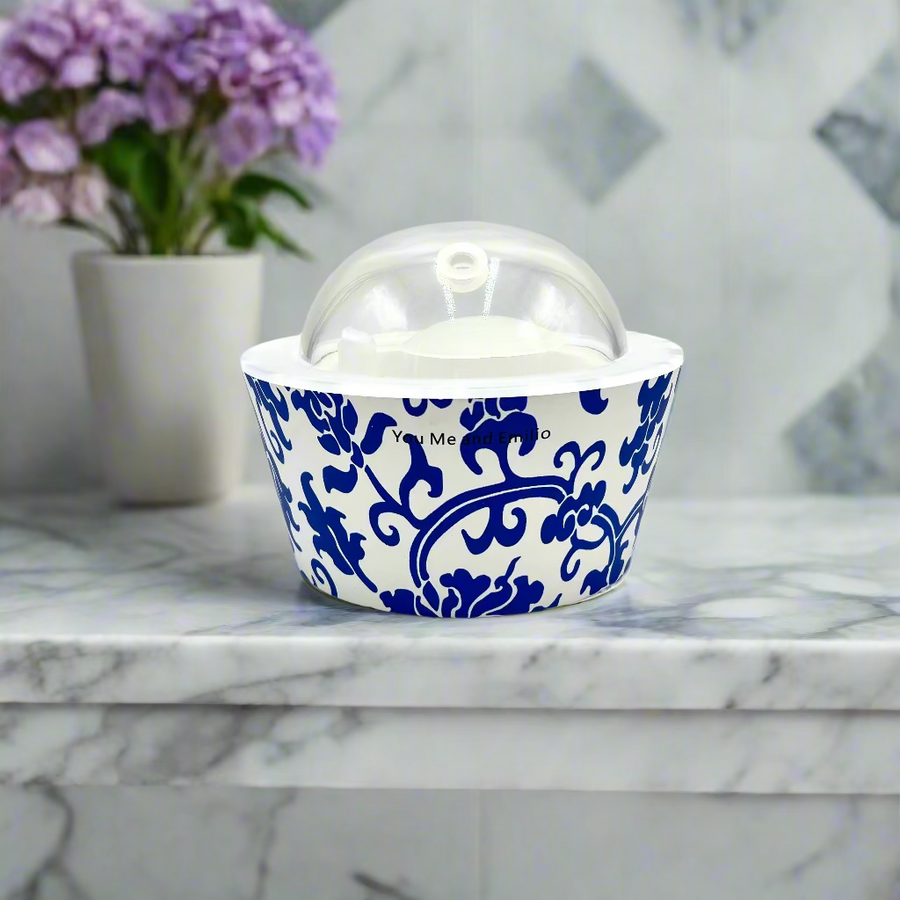 Blue and white ceramic container with a clear lid on a white background