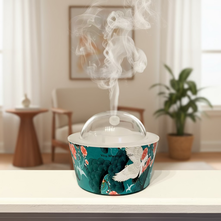 Decorative container with a lid on a white surface, featuring bird and floral design.