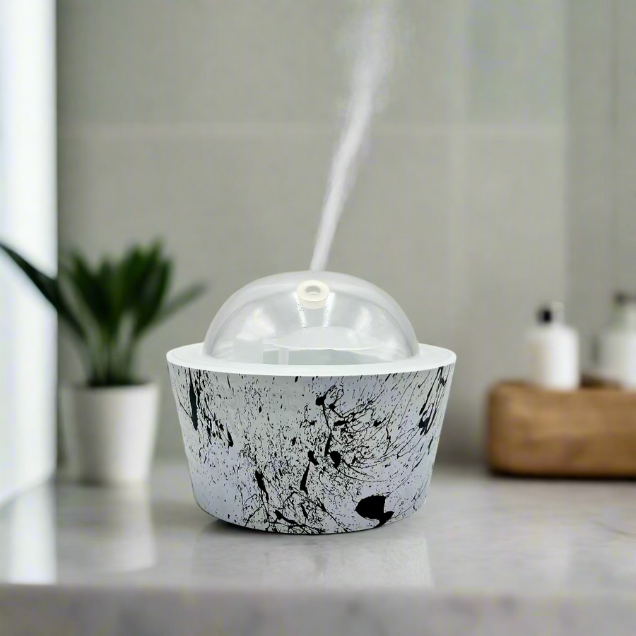 White container with black abstract design and a clear dome lid on a white background