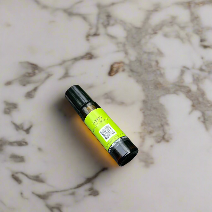 Amber glass bottle of Forty Scented Roll-On by You Me & Emilio, featuring bold musky and floral fragrance oil for daily wear, luxury scent rituals, and gifting.