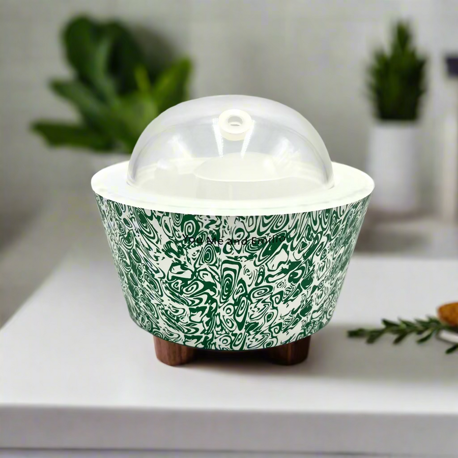 Green and white patterned container with a clear dome lid on a white background