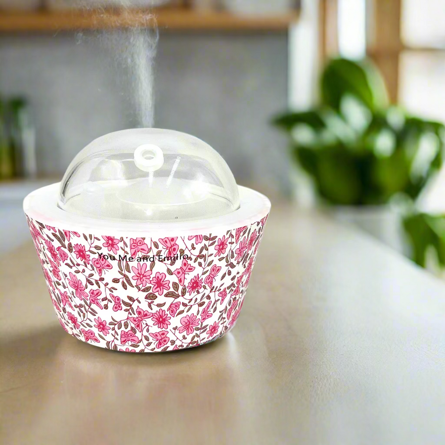 Floral-patterned container with a clear lid on a white background