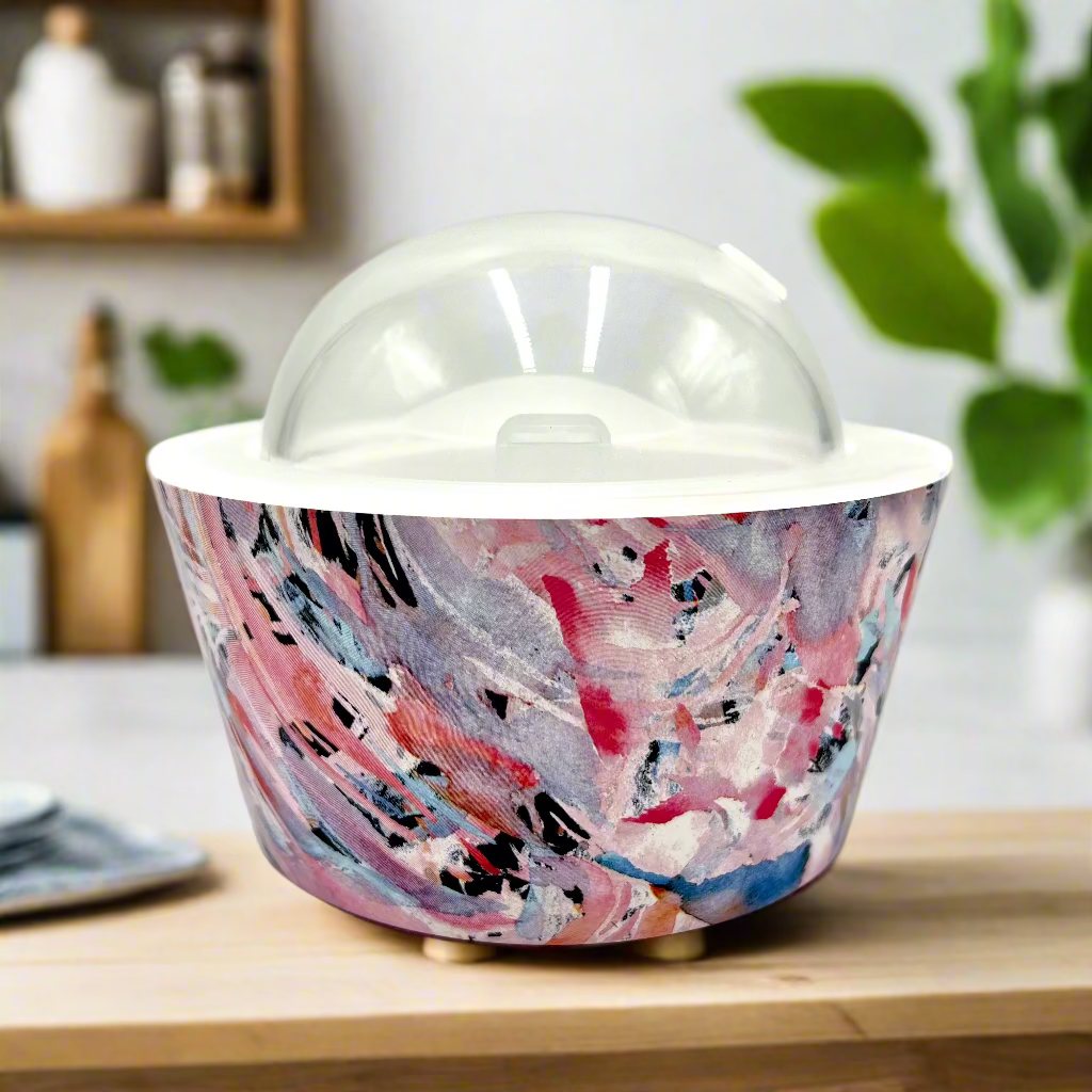 Colorful abstract-patterned container with a clear dome lid on a white background