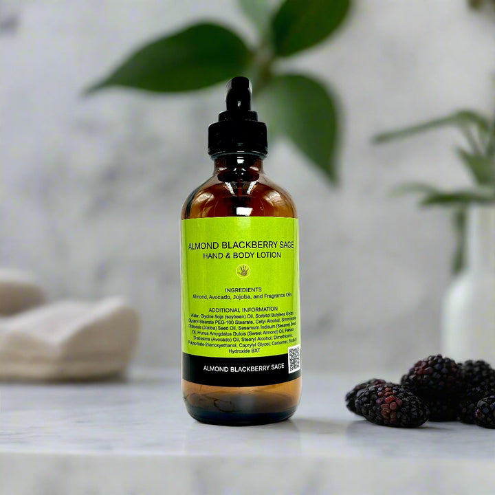 Bottle of Almond Blackberry Sage Lotion with a backdrop of fresh blackberries, almonds, and sage leaves.