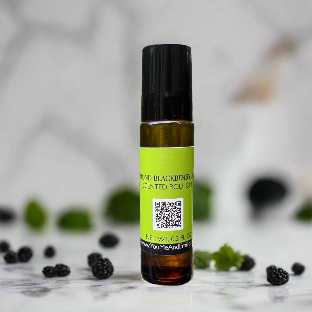 Amber bottle of Almond Blackberry Sage Roll-On Perfume Oil by You Me & Emilio, featuring notes of blackberry, sage, almond, and vanilla.