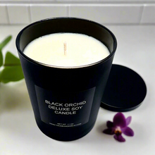 Limited-edition Black Orchid Soy Candle by YOU ME & EMILIO, glowing softly and setting a cozy, sophisticated mood.
