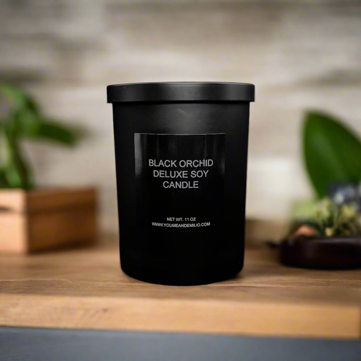 Black Orchid Deluxe Soy Candle in a sleek black jar, glowing warmly with an elegant and luxurious ambiance.