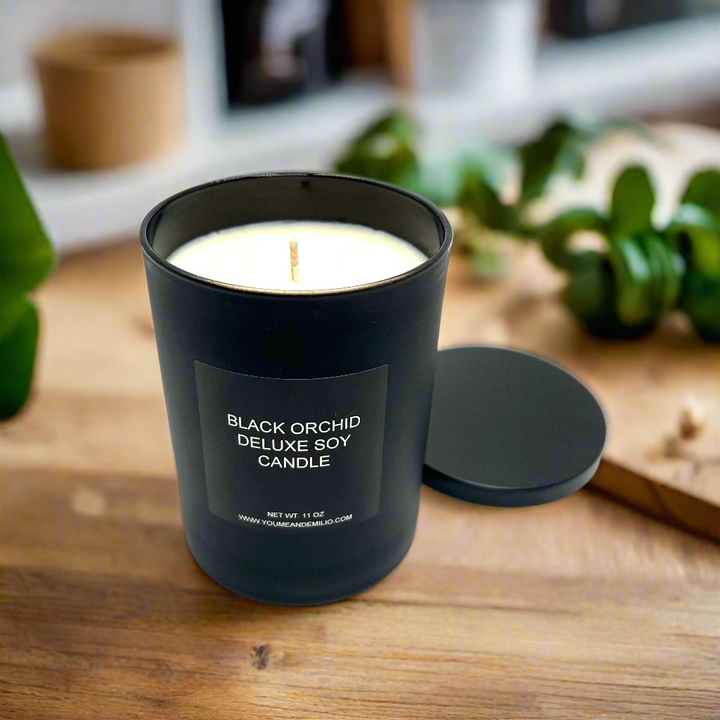 Chic and luxurious Black Orchid Deluxe Soy Candle, inspired by Tom Ford, illuminating a modern tabletop.