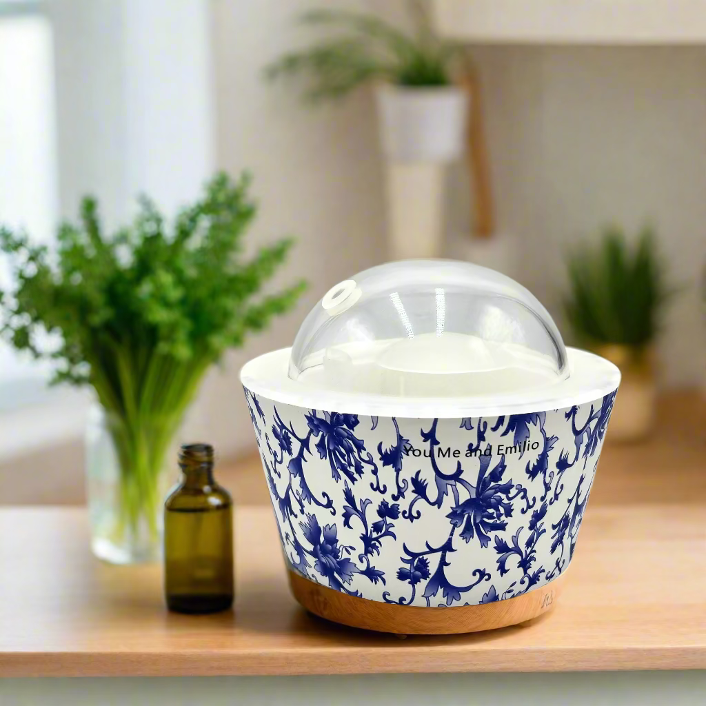 White container with blue floral pattern and a clear dome lid on a white background