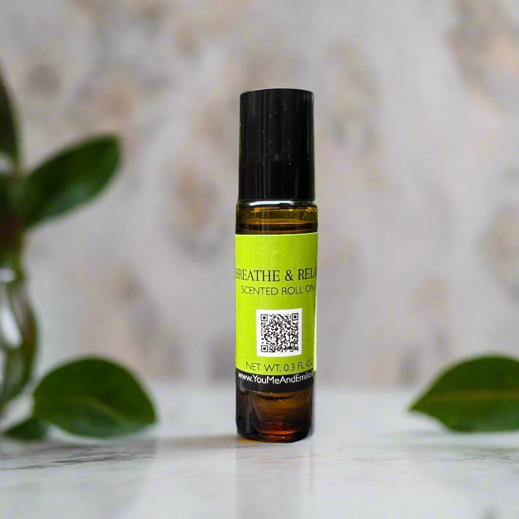 Breathe & Relax Scented Roll-On by You Me & Emilio in amber glass bottle, featuring eucalyptus and spearmint aromatherapy fragrance oil for relaxation.