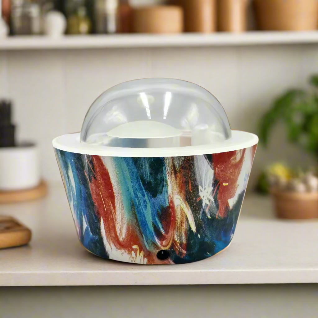Colorful abstract-patterned ice cream container with a clear lid on a white background