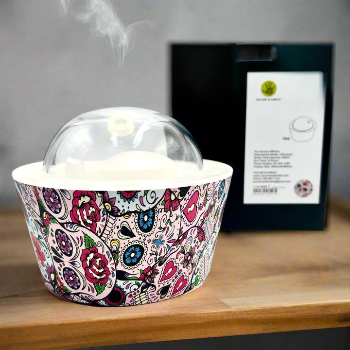 Bring calm and elegance to your space with our Day Of The Dead Catrina Oil Diffuser. Ultrasonic mist, 10-hour runtime & auto shut-off. Shop YOU ME & EMILIO.