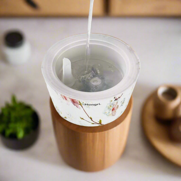 Cherry Blossom Essential Oil Diffuser with a 260ml water tank and a gentle mist rising in an elegant display.