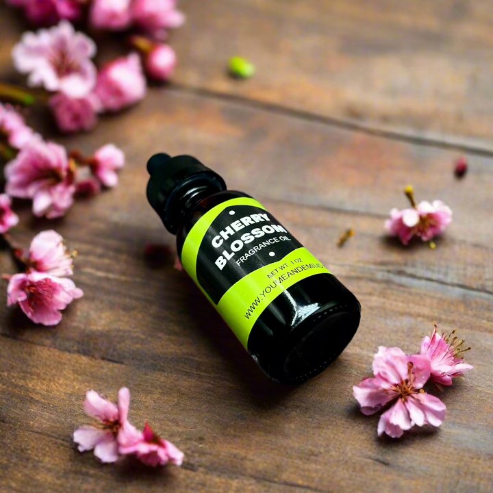 Cherry Blossom Fragrance Oil bottle with floral design, showcasing its luxurious, pure scent blend of cherry blossoms, jasmine, and peony. Hand-poured in Dallas, Texas.