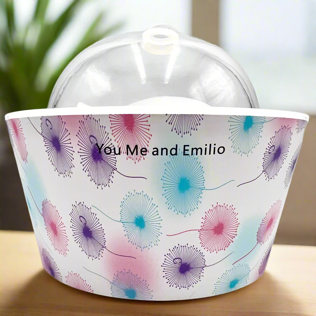 Decorative bucket with floral pattern and 'You Me and Emilio' text on a white background