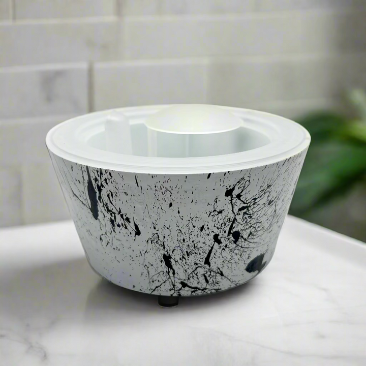 White container with black speckles on a white background