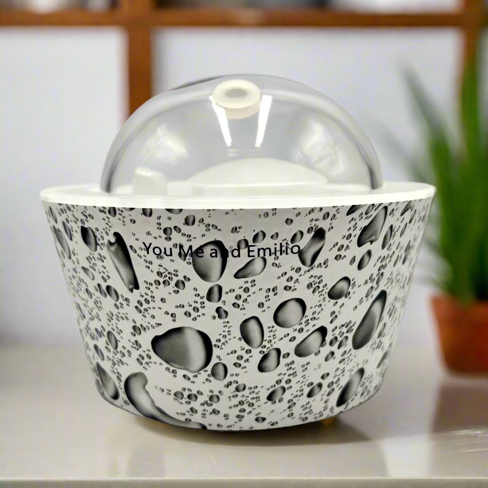 Decorative bowl with a textured design and a clear dome lid on a white background.