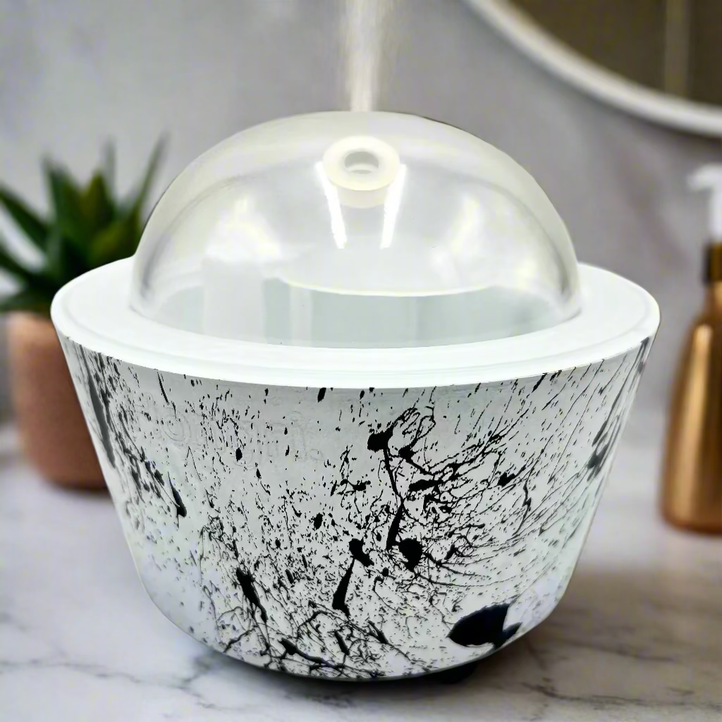 Ceramic bowl with black abstract design and clear lid on a white background