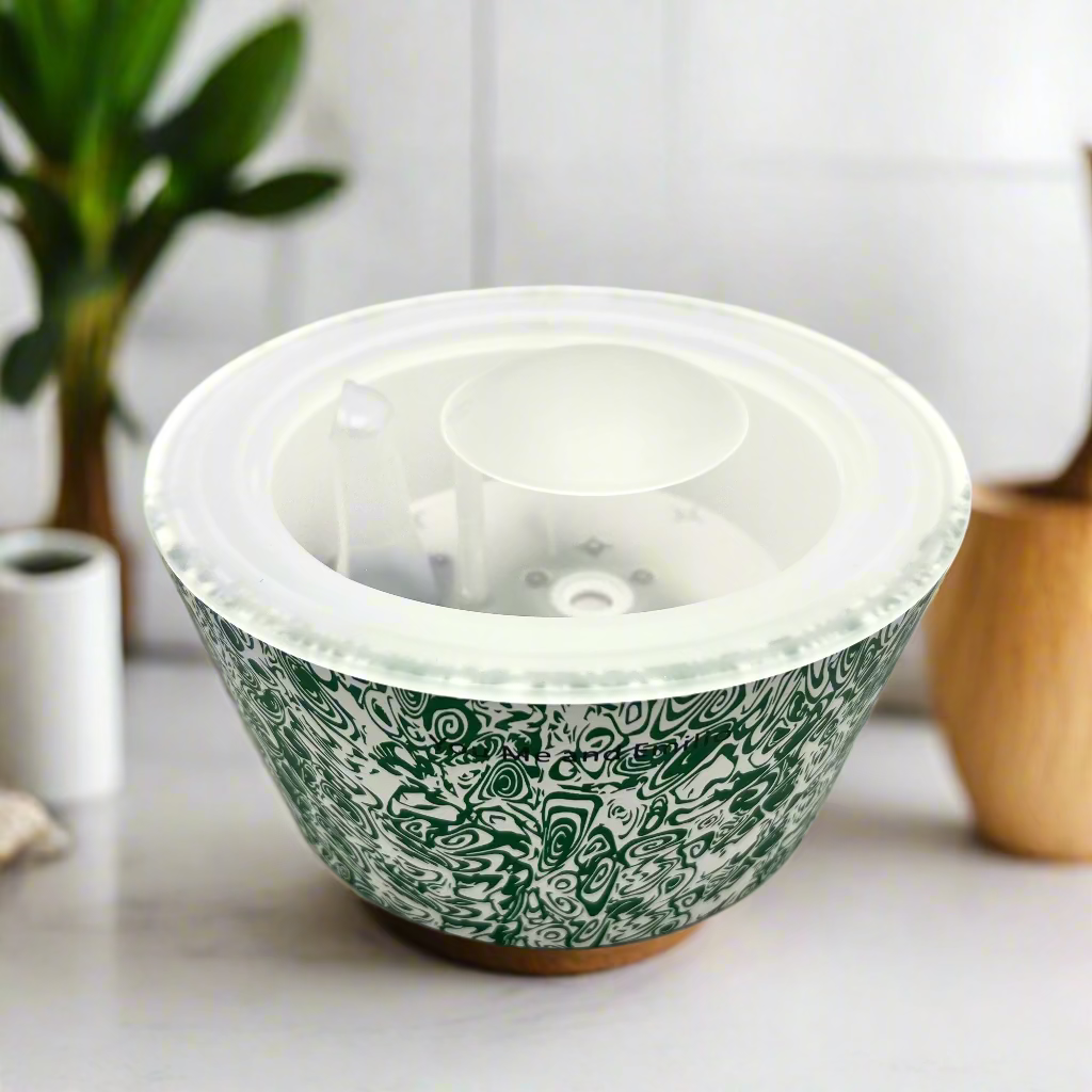 Green patterned bowl with a clear lid on a white background