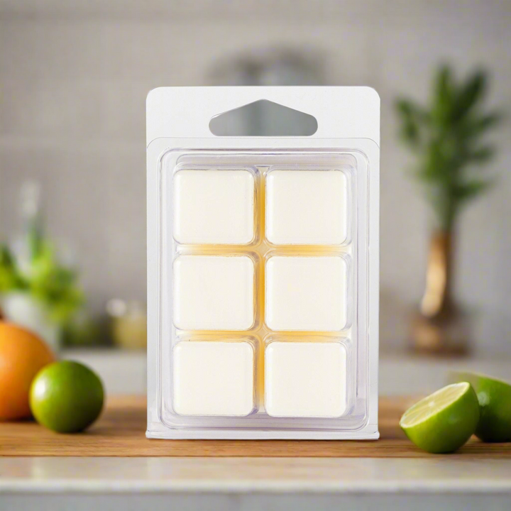Pack of wax melts on a kitchen counter with fruits and plants in the background