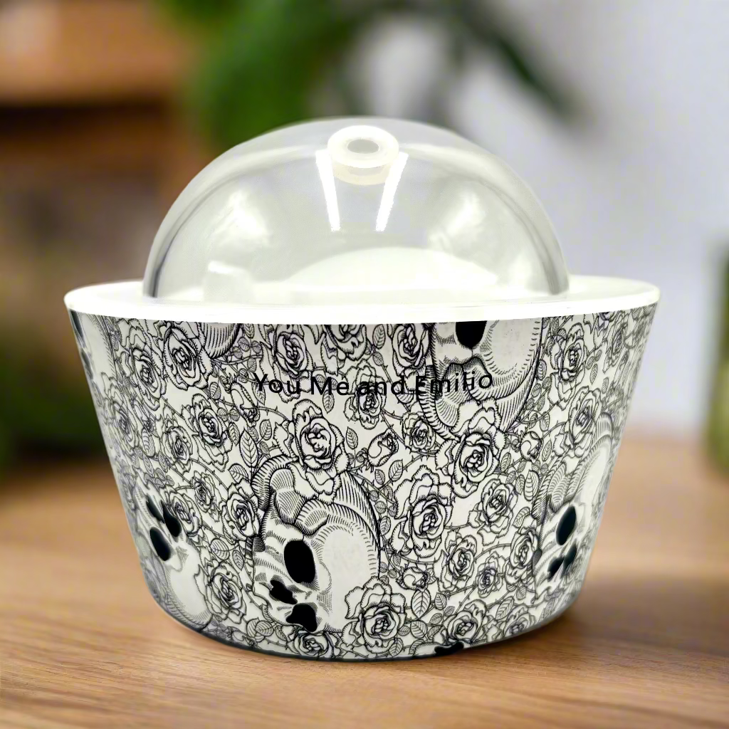 Decorative bowl with black and white skull and rose pattern on a white background