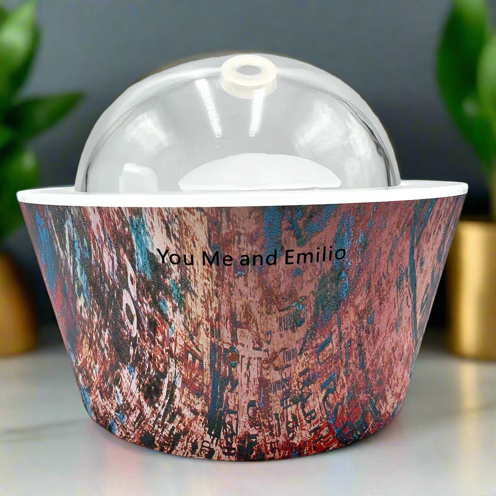 Artistic Essence Oil Diffuser, a masterful creation from Emilio Horton, founder of YOU ME &amp; EMILIO. Featuring a vibrant, textured abstract design of deep blues, fiery reds, and shimmering gold, this diffuser transforms any space into a sanctuary of creativity, relaxation, and sensory delight.

More than just an aromatherapy tool, the Artistic Essence brings an immersive experience with the gentle sound of running water and soft mist creation, inspired by the tranquility of natural streams.