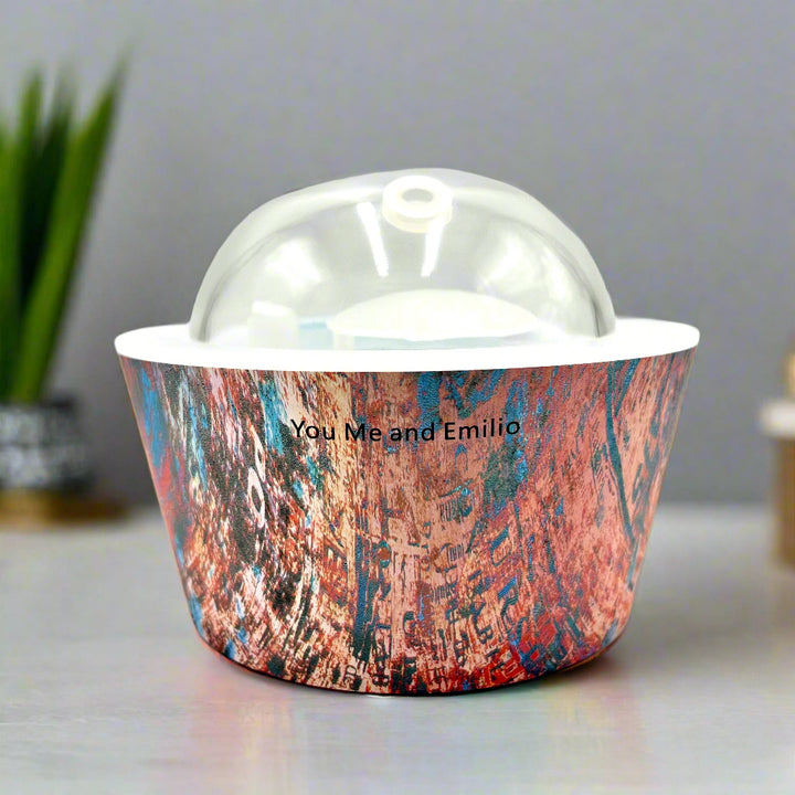 Artistic Essence Oil Diffuser, a masterful creation from Emilio Horton, founder of YOU ME &amp; EMILIO. Featuring a vibrant, textured abstract design of deep blues, fiery reds, and shimmering gold, this diffuser transforms any space into a sanctuary of creativity, relaxation, and sensory delight.

More than just an aromatherapy tool, the Artistic Essence brings an immersive experience with the gentle sound of running water and soft mist creation, inspired by the tranquility of natural streams.
