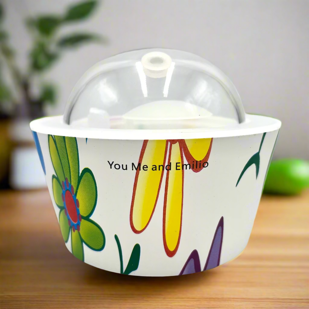 Decorative bowl with colorful floral design and clear lid on a white background