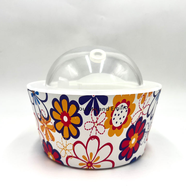 Colorful floral-patterned container with a clear dome lid on a white background