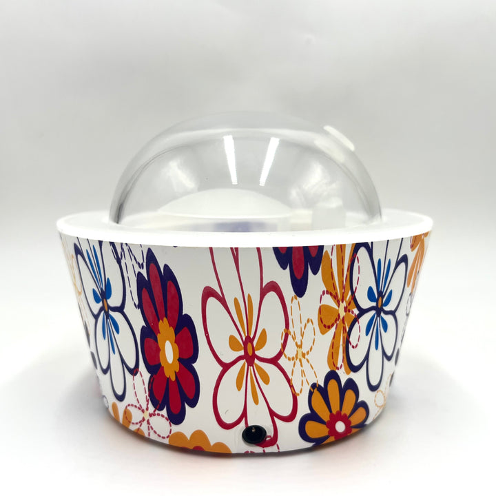 Colorful floral-patterned container with a clear lid on a white background