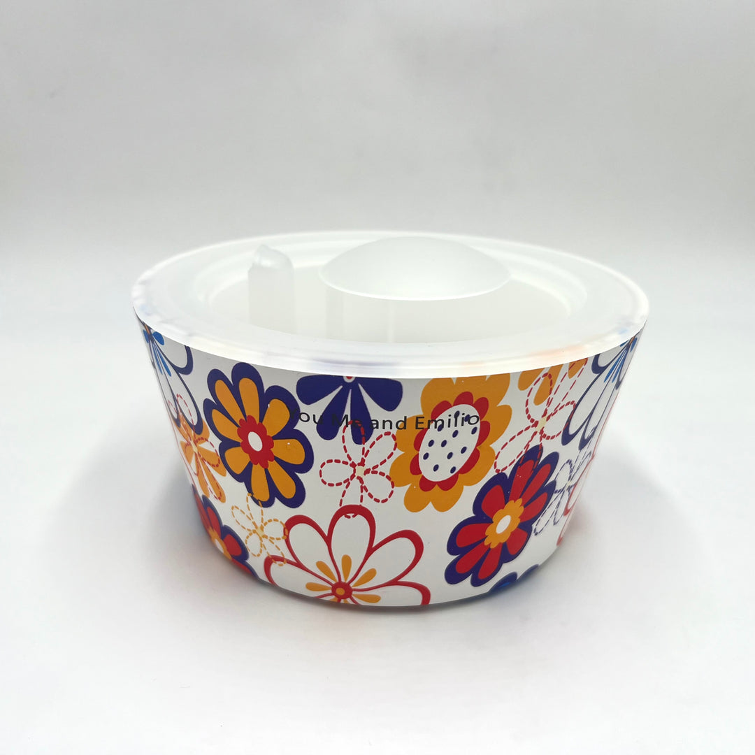 Plastic bowl with colorful floral pattern on a white background