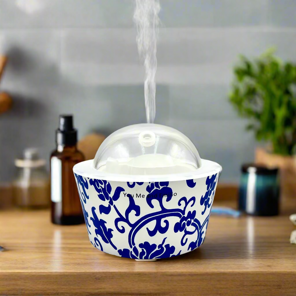 Decorative blue and white patterned container with a clear lid on a white background