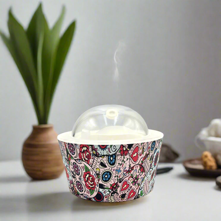 Bring calm and elegance to your space with our Day Of The Dead Catrina Oil Diffuser. Ultrasonic mist, 10-hour runtime & auto shut-off. Shop YOU ME & EMILIO.