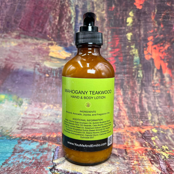 Flat lay of Mahogany Teakwood Hand & Body Lotion, nestled on a rustic wooden table with sprigs of geranium and lavender, reflecting its soothing and sophisticated fragrance.