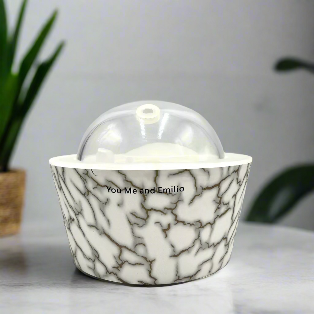 Marble-patterned container with a clear dome lid on a white background