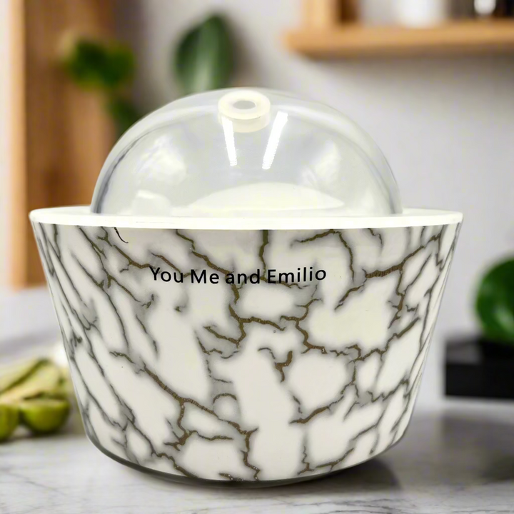 Marble-patterned bowl with a clear lid on a white background