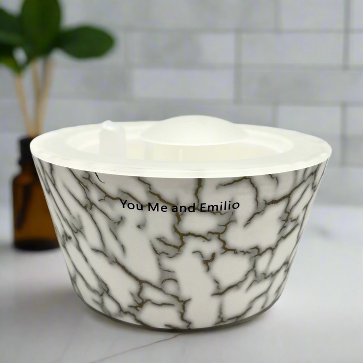 Marble-patterned bowl with 'You Me and Emilio' text on a white background