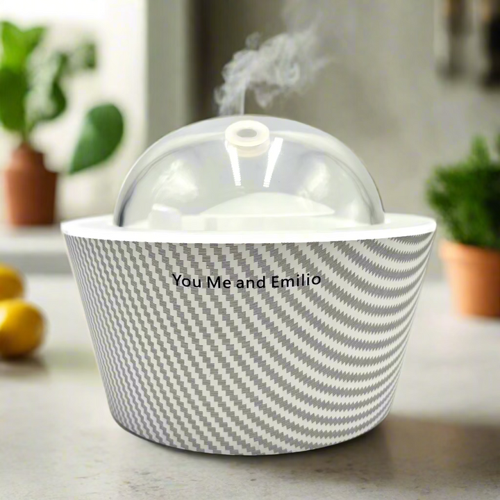 Ceramic bowl with a lid featuring a gray and white pattern on a light gray background.