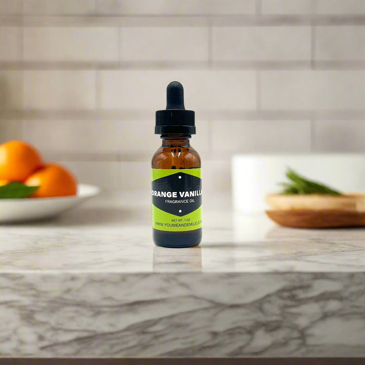 Bottle of orange vanilla fragrance oil with a dropper on a white background