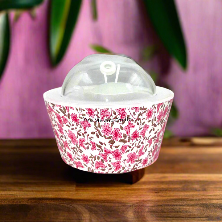 Floral-patterned container with a clear lid on a white background
