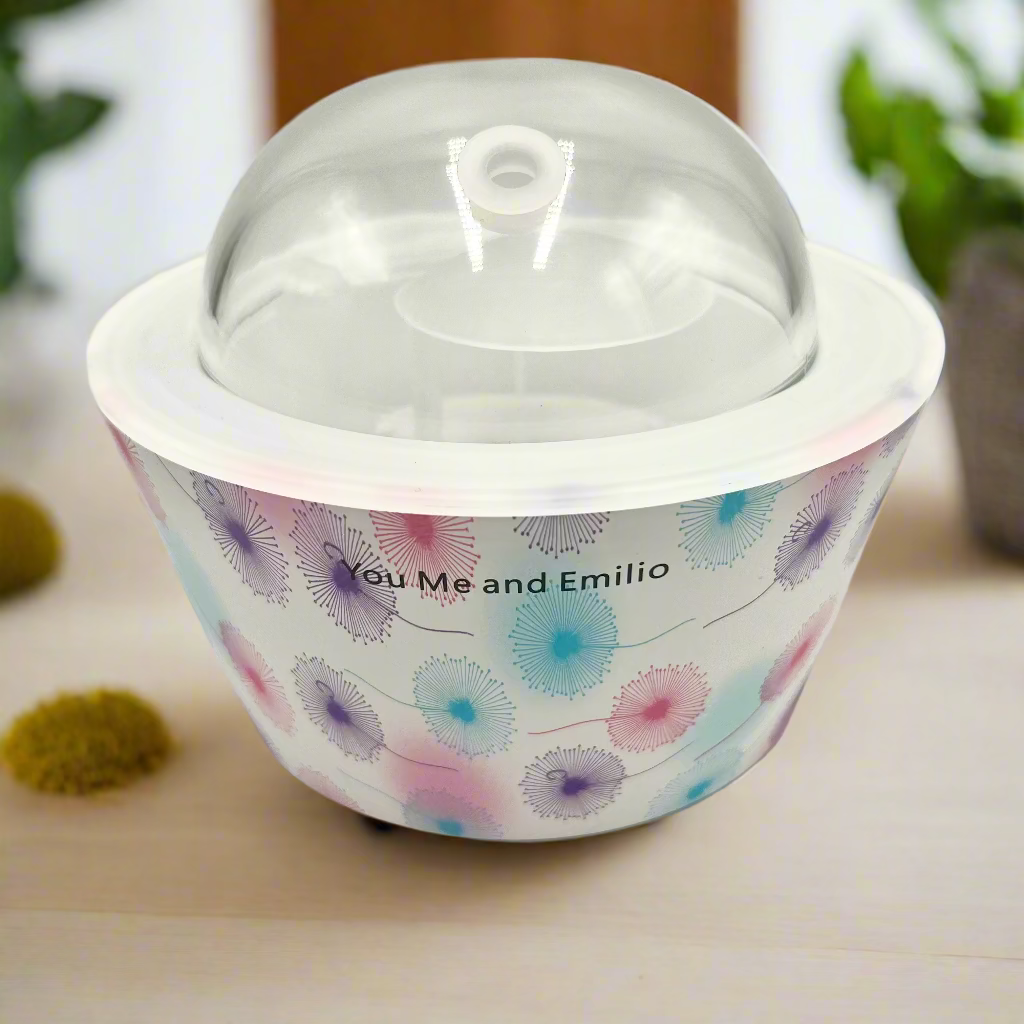 Round container with floral design and clear lid on a white background