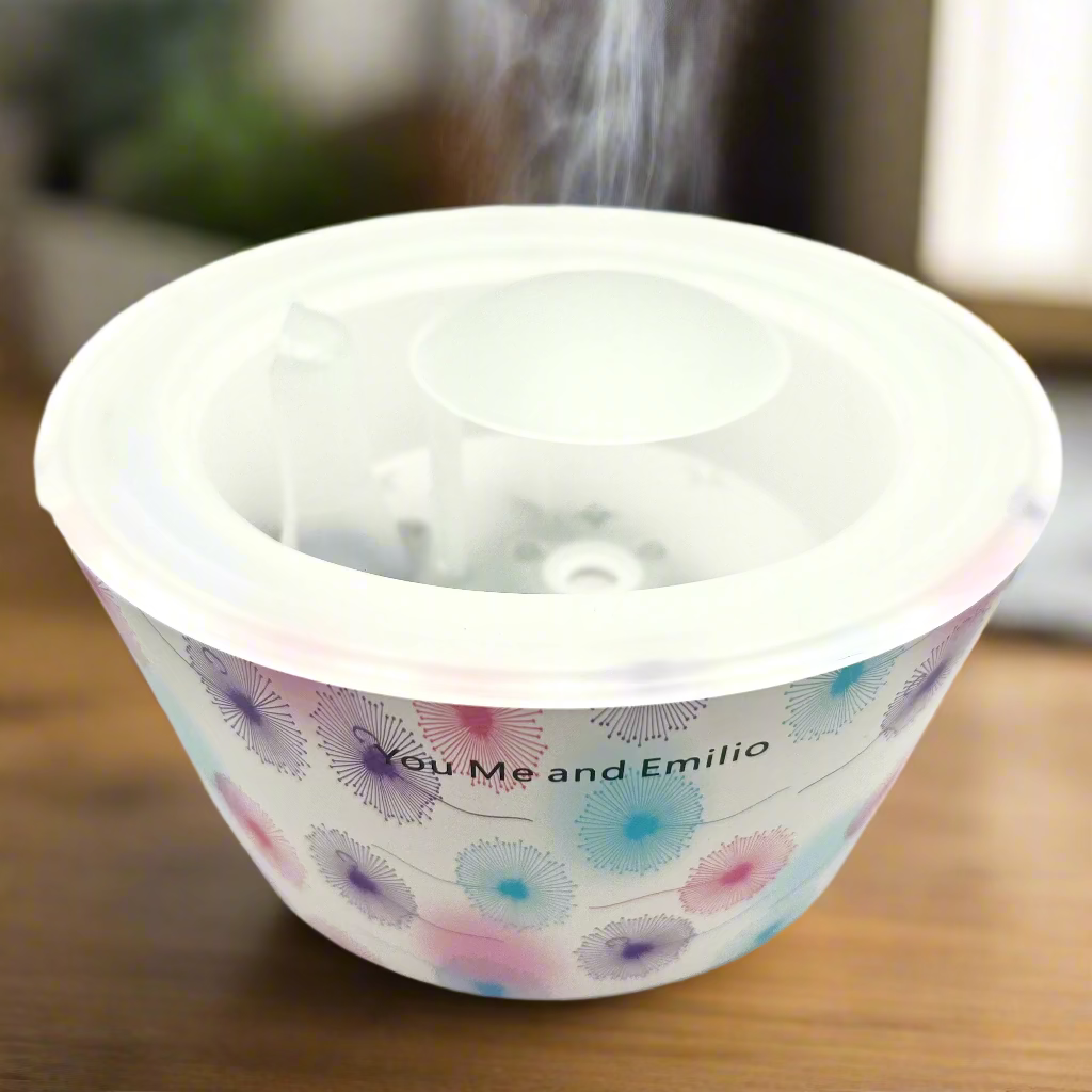 Round container with floral design and text on a white background