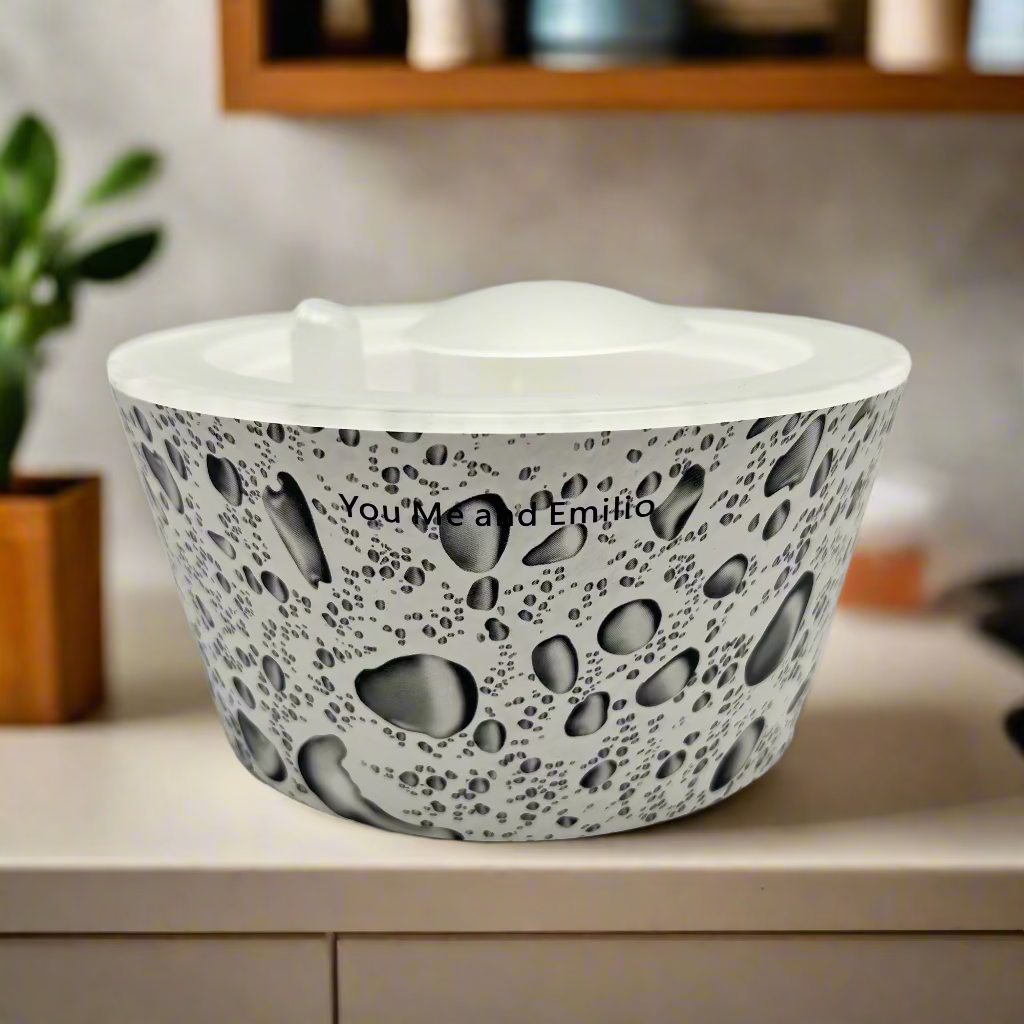 White plastic with rain drops bowl with black speckled pattern on a white background
