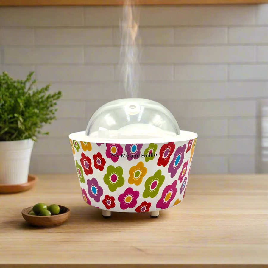 Colorful floral-patterned container with a clear dome lid on a white background