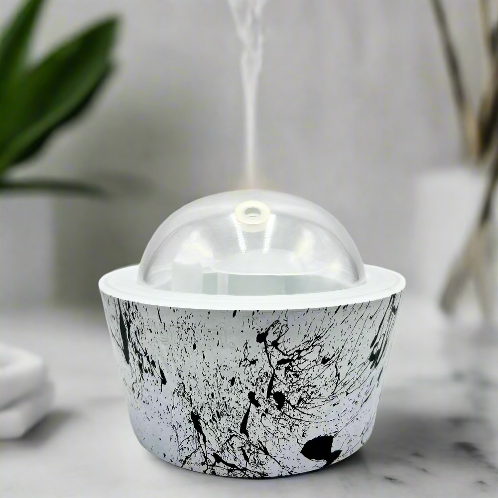 White container with black abstract pattern and clear dome lid on a white background