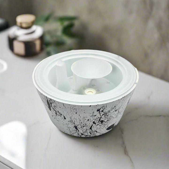Round container with marble pattern and clear lid on a white background