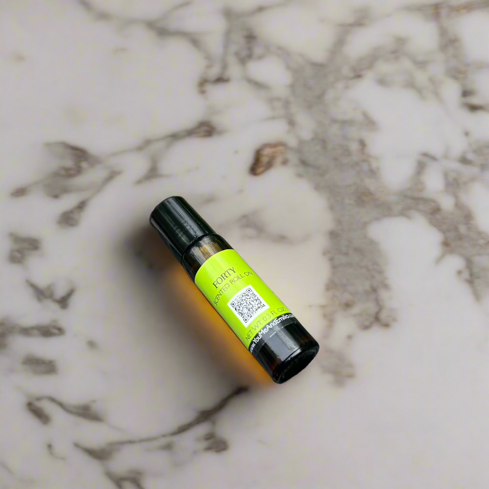 Amber glass bottle of Forty Scented Roll-On by You Me & Emilio, featuring bold musky and floral fragrance oil for daily wear, luxury scent rituals, and gifting.
